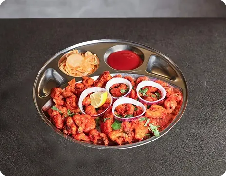 Crispy Cauliflower Appetizer Served with Fresh Onion at an Indian Restaurant in Croydon
