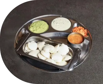 Soft Idli Served with Coconut Chutney and Tomato Chutney for a South Indian Breakfast