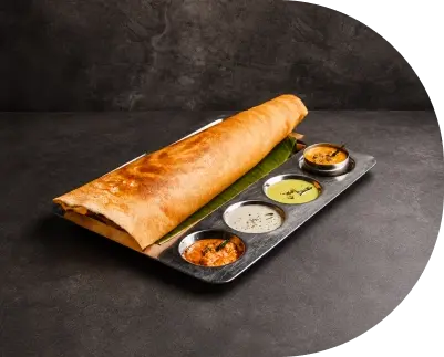 Crispy Folded Dosa Served on a Tray with Sambar and Chutneys 