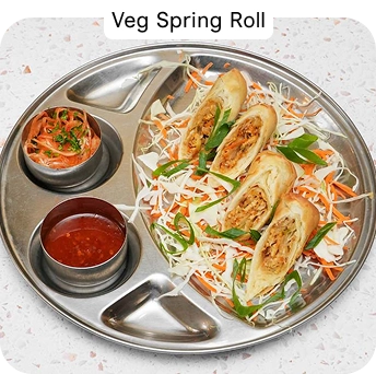 Vegetable Spring Rolls Served with Dipping Sauces at an Indian Restaurant