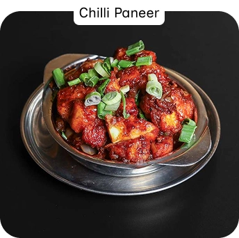 Spicy Chilli Paneer Garnished with Spring Onions at an Indian Restaurant in Croydon