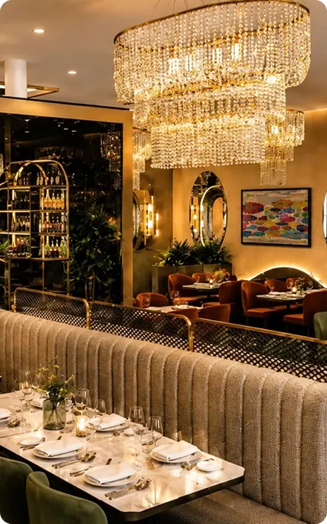 Elegant South Indian restaurant interior with chandeliers and beautifully set dining tables